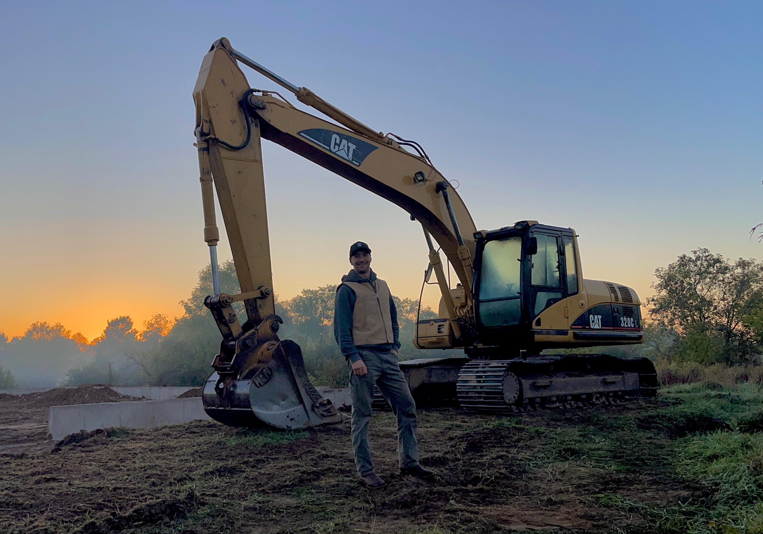 Excavator doing land clearing for farming project in Cambridge, Ontario
